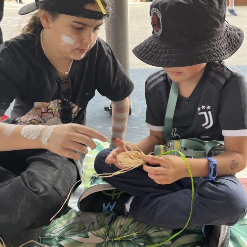 Children learning to traditional weave
